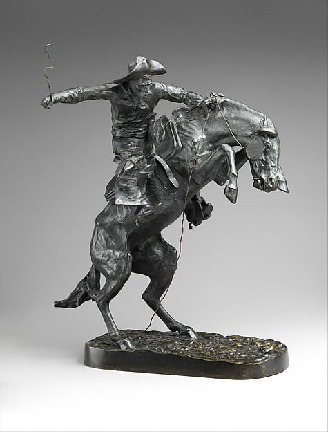 Bronze sculpture of a cowboy riding a rearing horse